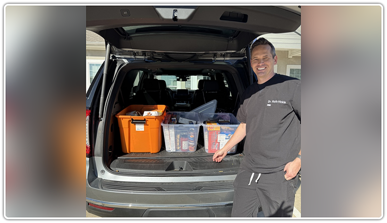 Dr. Hinkle next to packed van