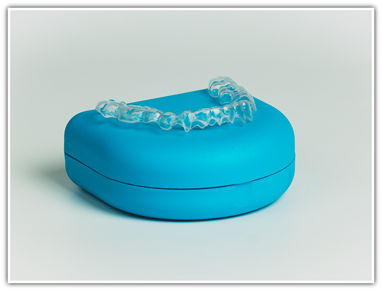 Invisalign clear aligner sitting on top of case