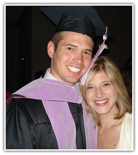 Dr. Hinkle in graduation cap smiling with woman