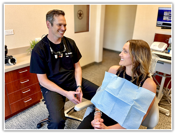 Dr. Hinkle talking to female dental patient