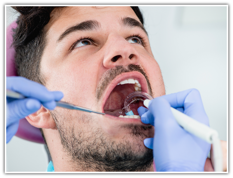 Male dental patient having teeth examined