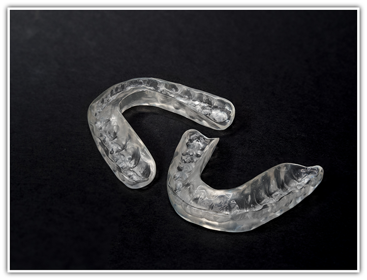 Close-up of nightguards on black surface