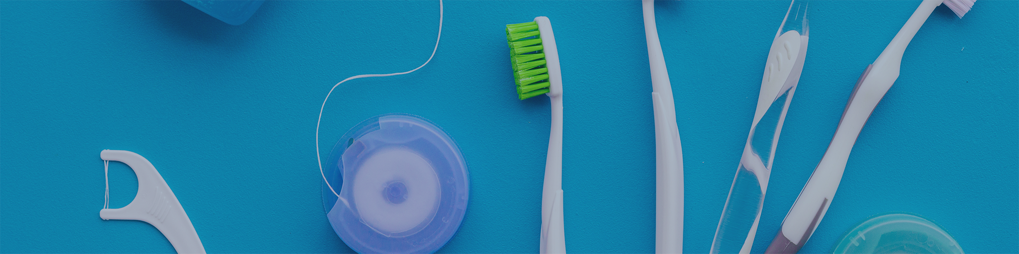 Close-up of toothbrush dental floss and other oral hygiene implements