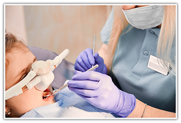 Patient having teeth examined while receiving dental sedation