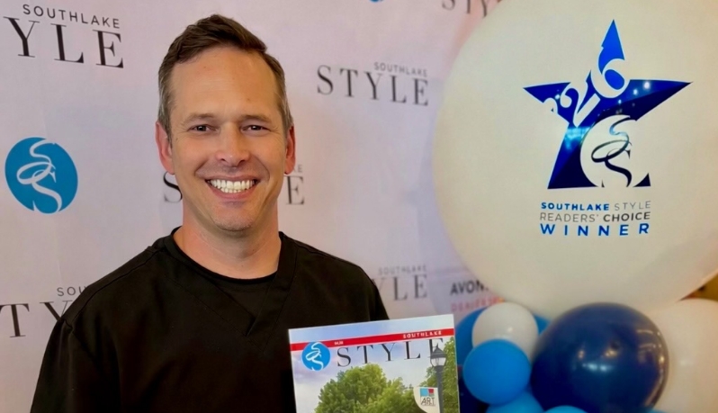 Doctor Hinkle holding a Southlake Style magazine