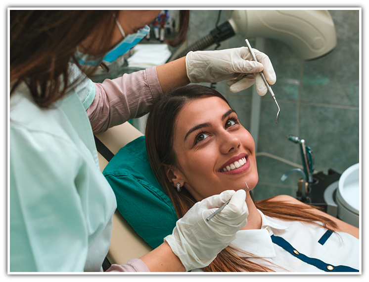 Female patient having teeth cleaned by dentist