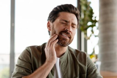 Man dealing with tooth pain.