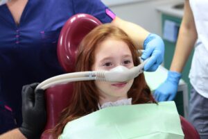 Young girl getting laughing gas